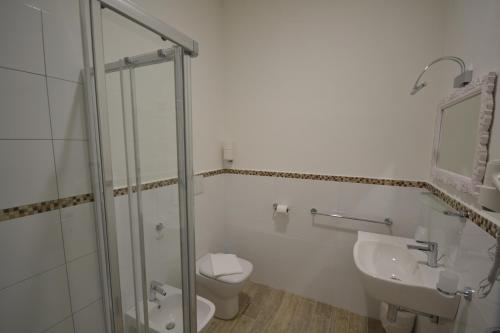 a bathroom with a shower and a toilet and a sink at Affittacamere Casa Dane' in La Spezia