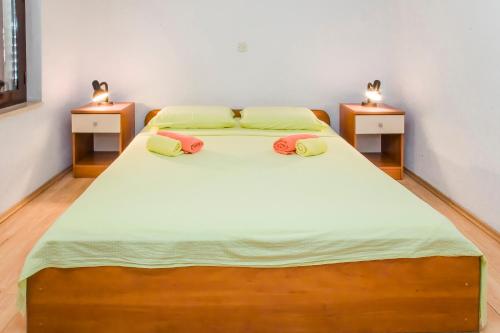 a bedroom with a large bed with two night stands at Ante Apartments in Trstenik