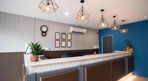 a lobby with a bar with a clock on the wall at Ipoh Sakura Hotel in Ipoh