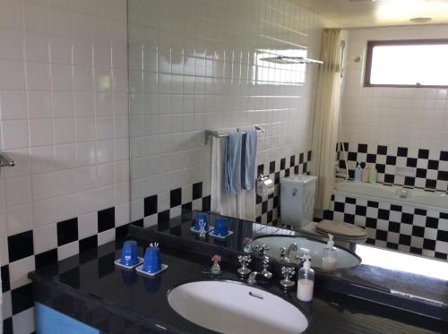 a bathroom with a sink and a toilet at Mayagusuku Resort in Iriomote