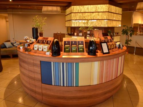 a lobby with a large circular counter with radios at Atami Seaside Spa & Resort in Atami