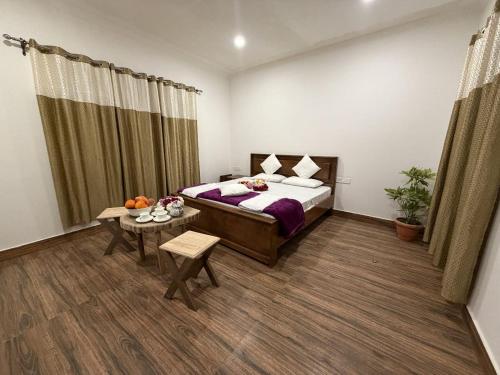 a bedroom with a bed and a table in it at Kashmir Beautiful Villa in Srinagar