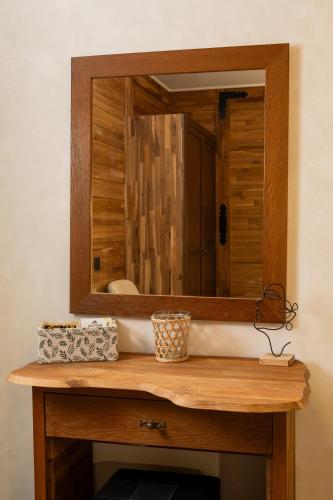 a bathroom sink with a mirror on top of it at Valevtsi Mount Lodge - 365 days hot outdoor pool - in Valevtsi