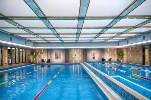 a large swimming pool with blue water at Radegast Hotel CBD in Beijing