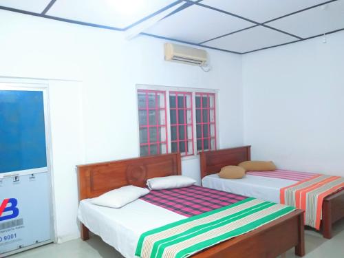 Ένα ή περισσότερα κρεβάτια σε δωμάτιο στο NK Hotel & Resturaunt