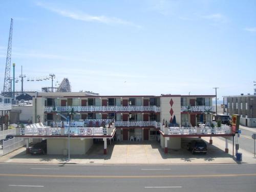 a large building with two balconies on a street at Casa Del Sol Motel in Wildwood