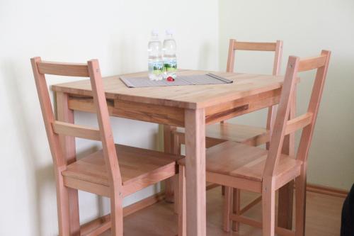a wooden table and two chairs with glasses on it at Apartment Favoritenstraße in Vienna