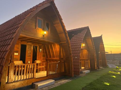 a row of wooden homes at sunset at Villa Aiden Bungalow 3 near luwatu in Ungasan