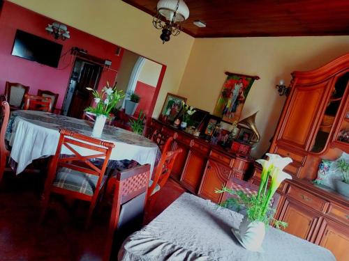 a room with a table and chairs and a room with red walls at Ragith Villa in Nuwara Eliya