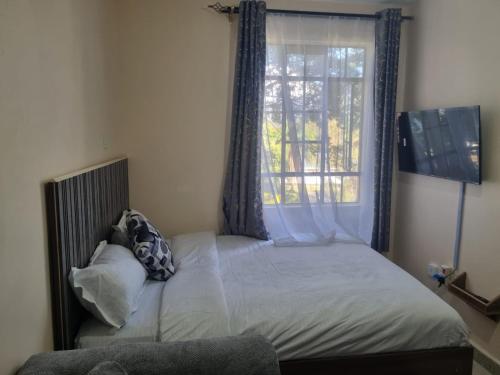 Ένα ή περισσότερα κρεβάτια σε δωμάτιο στο Tabz BnB