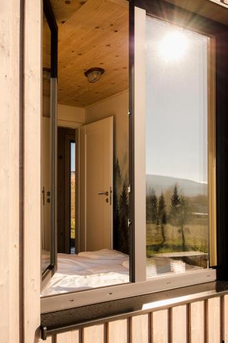 a window in a house with a view of a bed at Hvile, gmina Brenna - BESKIDY in Górki Wielkie