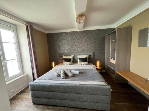 a bedroom with a large bed and two windows at Le Phoenix 449 , vue mer, 2 chambres in Arromanches-les-Bains