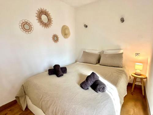 a bedroom with a bed with two pillows on it at Chez Tao in Carqueiranne