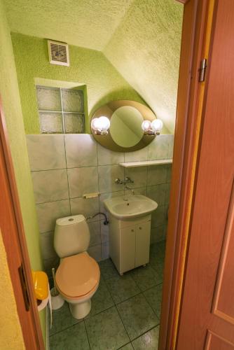 a small bathroom with a toilet and a sink at Uroczy domek nad jeziorem in Lubikowo
