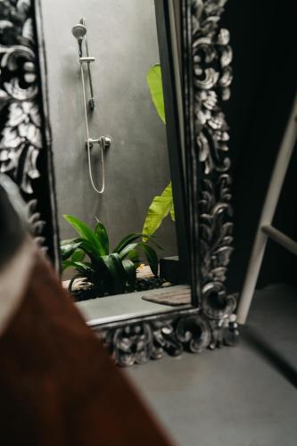 a mirror sitting on a table with a shower at SPICE TRADER in Nusa Penida
