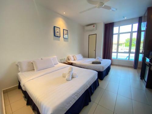 Postel nebo postele na pokoji v ubytování Mak Sa'adiah Hotel