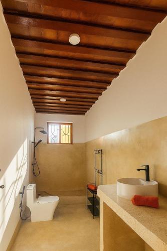 a bathroom with a white toilet and a sink at Villa Katerina-Zanzibar Apartment Paje in Paje