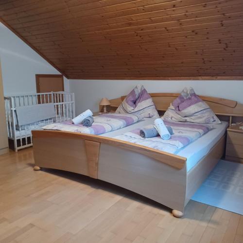 a bedroom with a large bed with purple pillows at Ferienhaus Renate in Straden