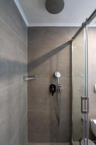 a shower stall with a glass door with a shower at Sentido Luna Vista Belek Hotel in Belek