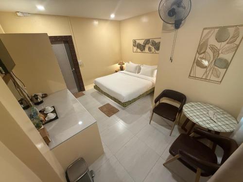 a bedroom with a bed and a table and a chair at Khlong bang phra boutique hotel in Trat