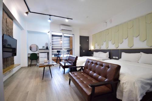 a bedroom with a large bed and a couch at Zhiben Wu Jiari in Wenquan