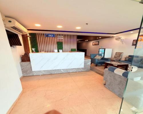 a living room with a couch and a table at Hotel Melano Ambala Chandigarh Rd Zirakpur SkyJumper park in Zirakpur