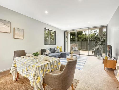 a living room with a table and chairs at Chatswood Gem Steps to Metro, Mall & Park in Sydney