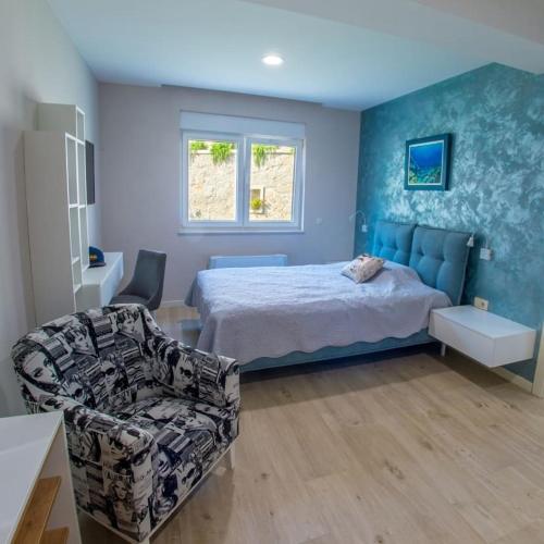 a bedroom with a bed and a couch and a chair at Apartamento Italia in Međugorje