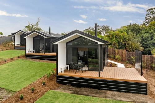 a modular home with a deck and a backyard at Grevillea Villa in Valdora