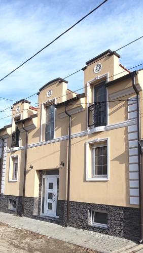 a large yellow building on the side of a street at MJ apartments - Villa Bulik in Vršac