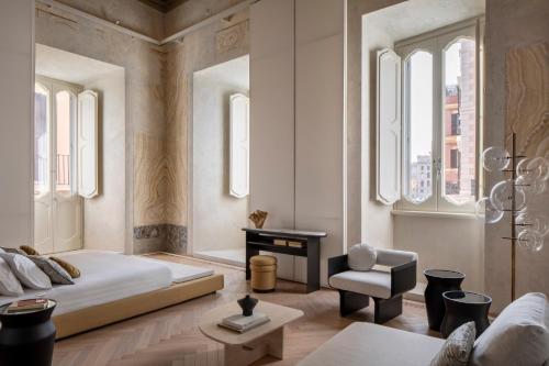 a bedroom with a bed and a chair at Hotel Trame in Rome