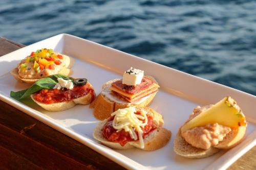 a plate of food in a boat on the water at Boat Komodo in Seminyak