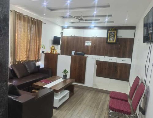a living room with a couch and a table at Hotel O Malani Inn in Kukatpalli