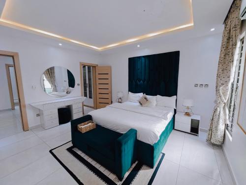 a bedroom with a large bed and a mirror at Sahara Apartment Ikoyi in Lagos