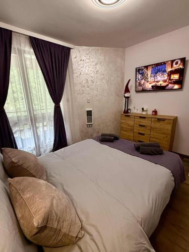 a bedroom with a large white bed and a window at Dream Apart - Iceberg in Pamporovo