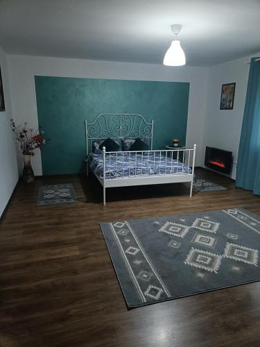 een slaapkamer met een bed en een groene muur bij Apartament terasa in Boekarest