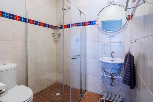 a bathroom with a shower with a toilet and a sink at 163 on Kusweg in Hartenbos