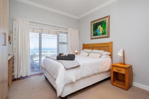 a bedroom with a bed with a view of the ocean at 163 on Kusweg in Hartenbos