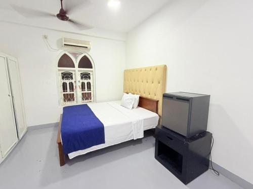 Ένα ή περισσότερα κρεβάτια σε δωμάτιο στο Trinco Hybrid Comfort Inn