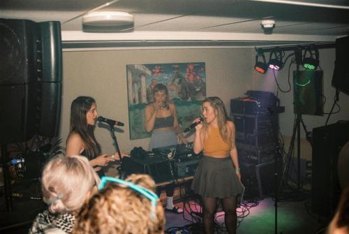 Eine Gruppe von drei Frauen, die in einem Raum singen in der Unterkunft Balestrand Hotel in Balestrand
