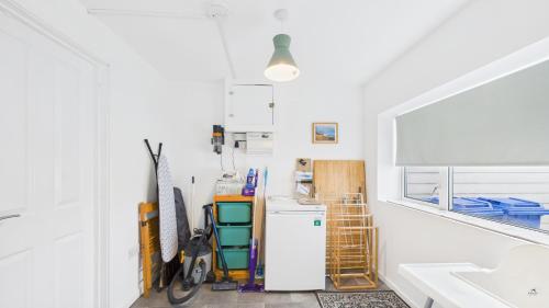 a kitchen with a refrigerator and a sink at Sea Breeze in Brading
