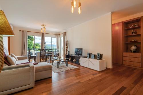 a living room with a couch and a table at Freitas House by Homie in Ponta do Sol