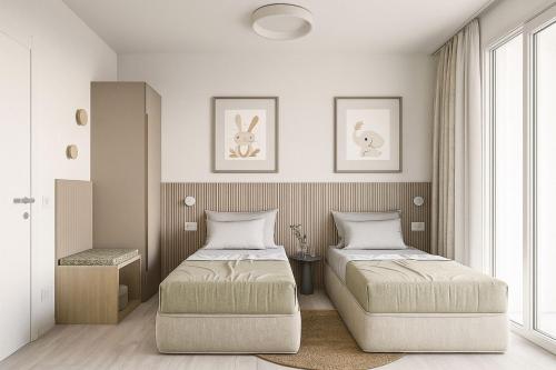 a bedroom with two beds and a window at Vibra Tahiti Deluxe in Lido di Jesolo