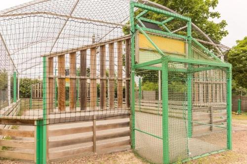 a green cage with a building in it at ZEcamping 3 étoiles animé animaux acceptés familial piscine couverte in Avrillé