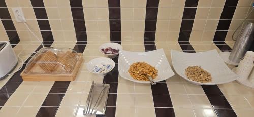 a counter top with bowls of food on it at Tradiup Hotel by the Designers in Seoul
