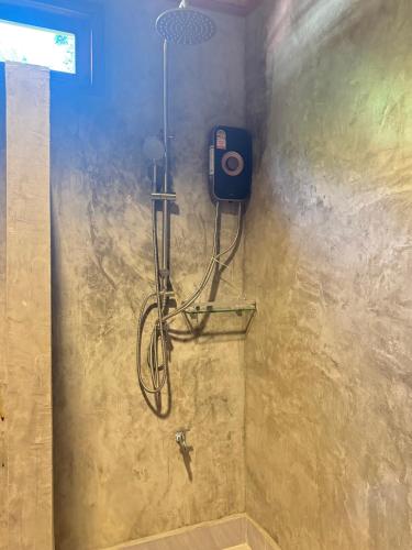 a shower in a bathroom with a shower at Painon Resort KohLanta in Ko Bu Bu