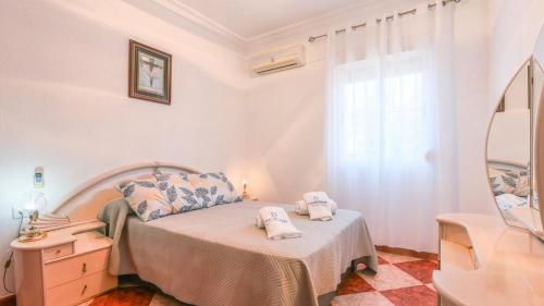 a bedroom with a bed with towels on it at Villa Josara by Ruralidays in Huelva