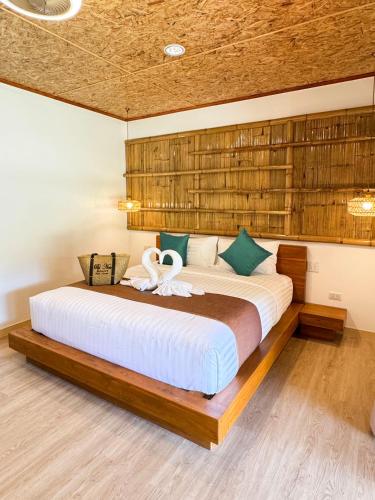 a bedroom with a large bed with a swan on it at Painon Resort KohLanta in Ko Bu Bu