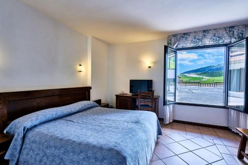 Postel nebo postele na pokoji v ubytování Hotel Pizzalto