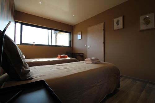 En eller flere senge i et værelse på Gîte Au Camp de Base vue panoramique